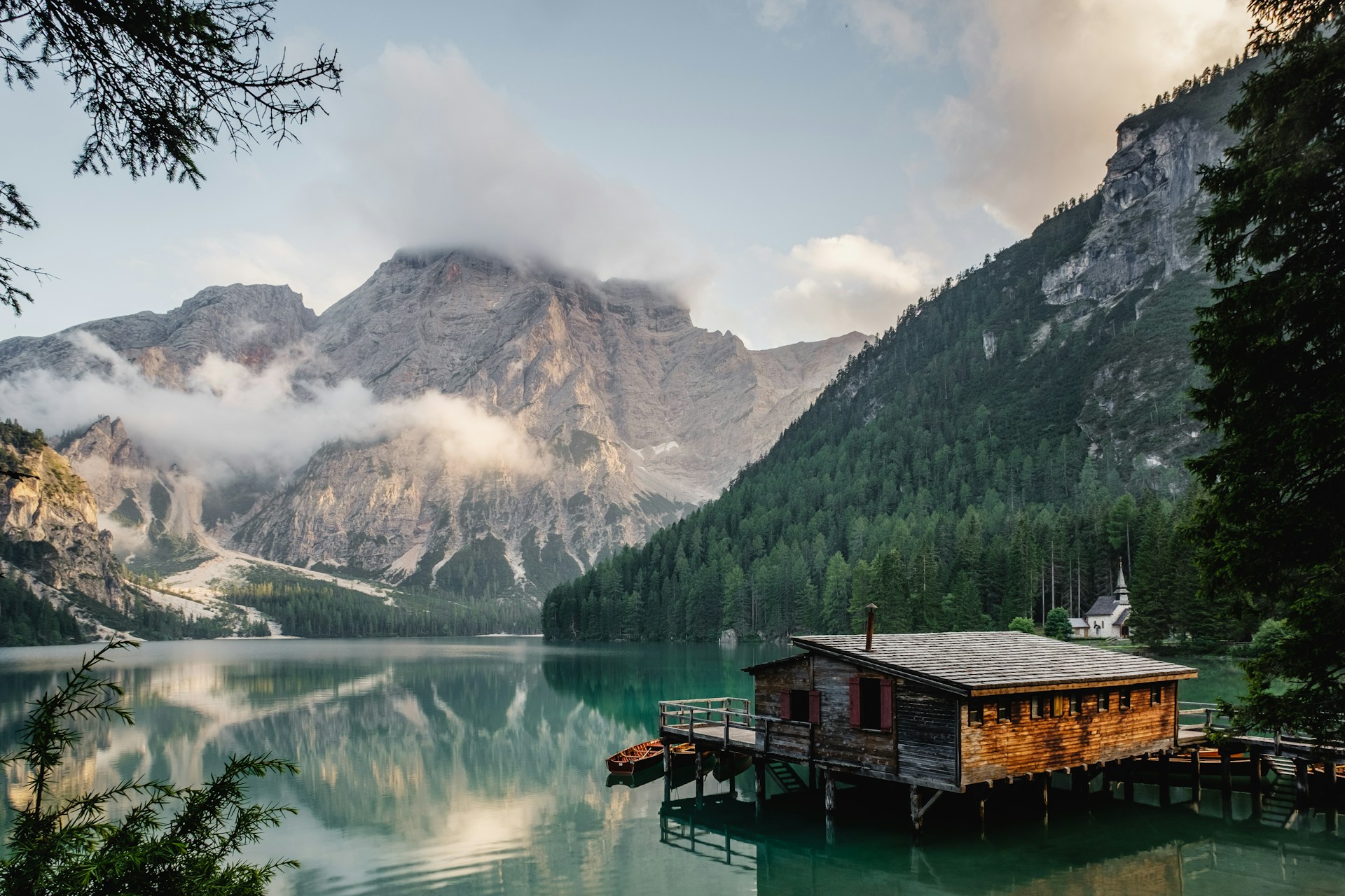 Mountains and forest reflected in a still alpine lake